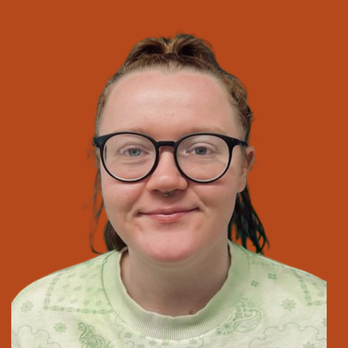 Lucy, Marketing Executive at Silver Apples Digital, wearing glasses and smiling against an orange background.
