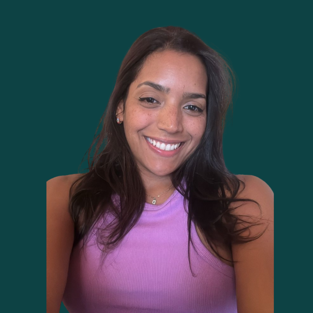 Daniela, Content Creator at Silver Apples Digital, smiling against a dark green background.